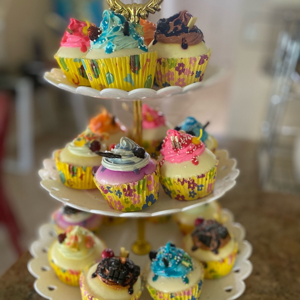 Realistic fake cupcakes on three tier tray